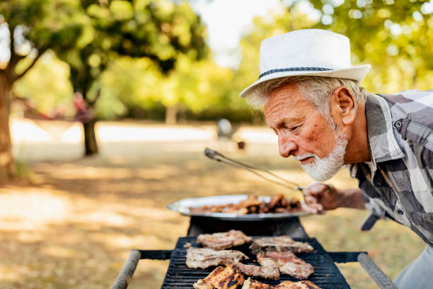 istock Senior Man at Barbecue party 1182123426