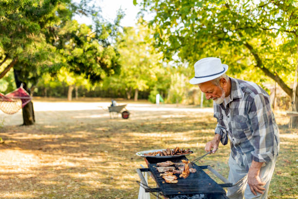 istock Senior Man at Barbecue party 1182123460