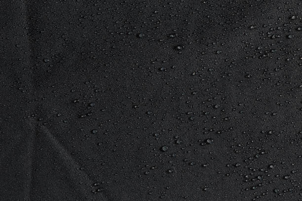 istock dark gray waterproof hydrophobic flat cloth closeup with rain drops background 1182126923