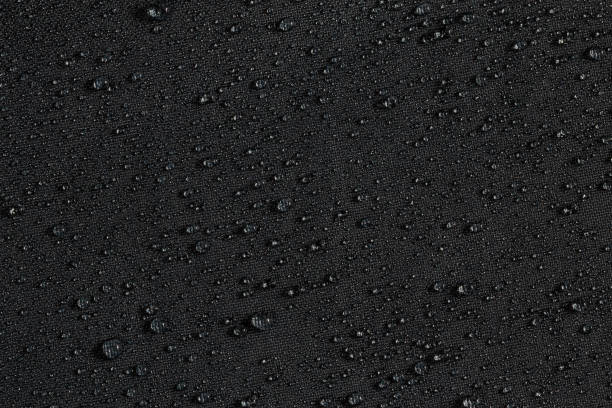 istock dark gray waterproof hydrophobic flat cloth closeup with rain drops background 1182126939