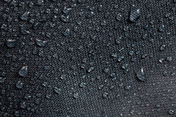 istock dark gray waterproof hydrophobic cloth closeup with water drops selective focus background 1182127093