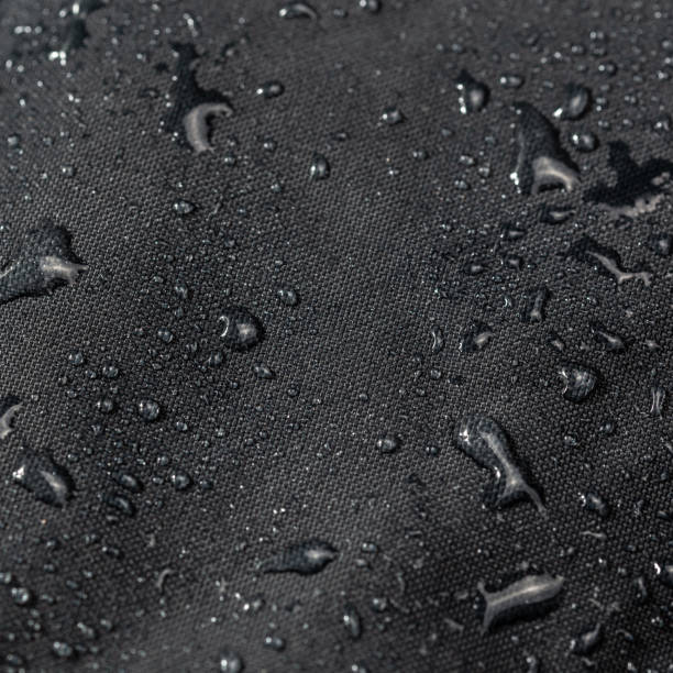 istock dark gray waterproof hydrophobic cloth closeup with water drops selective focus background 1182127099