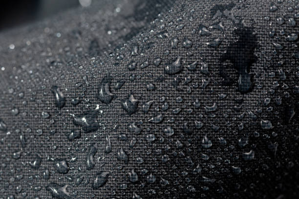istock dark gray waterproof hydrophobic cloth closeup with water drops selective focus background 1182127109