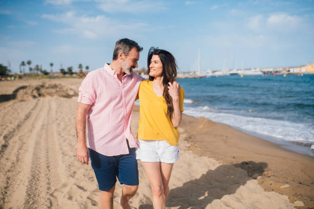 istock Happy couple enjoying on the beach 1182130396