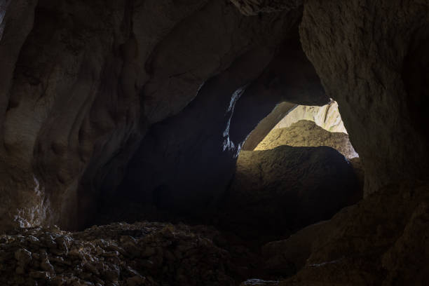 istock Light at the end of the massive cave 1182134081