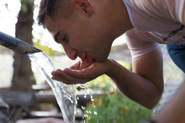istock Tourist Drinking Water From Public Fountain 1182137308