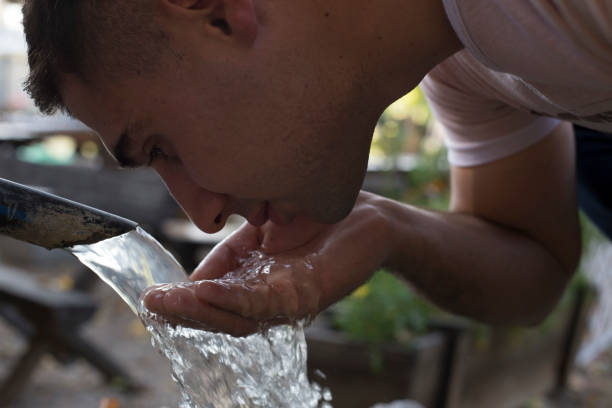 istock Tourist Drinking Water From Public Fountain 1182137969