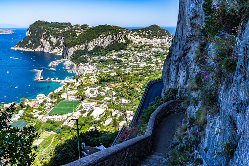 Looking down the steps of the Scala Fenicia (Phoenician Steps) with Capri Marina Grande and Punta del Capo in the background, Campania, Italy