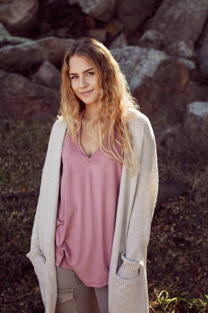 istock Young woman smiling while enjoying a lone walk in nature 1182138739