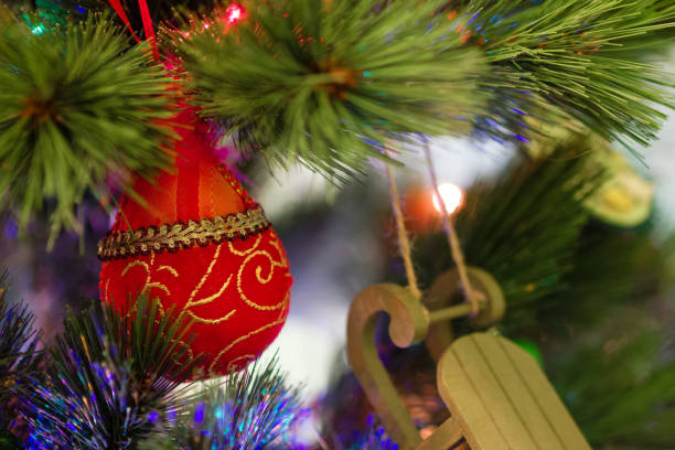 istock Colorful Christmas decorations on a fir tree with blurred lights. 1182139493