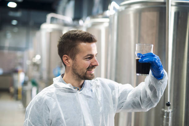 istock Technologist checking product quality in beverage alcohol production plant. 1182142024