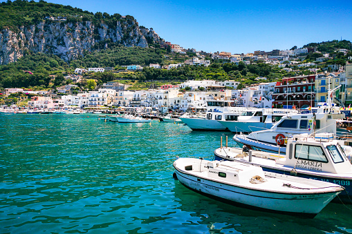 Colorful boats moored at Marina Grande, the main port of Capri island. Capri, Campania, Italy, June 2019