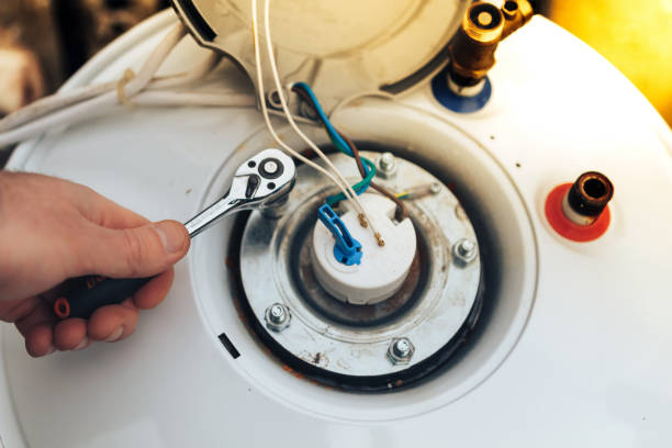 istock the worker has finished servicing the boiler and tightens the last nuts.close up 1182143146