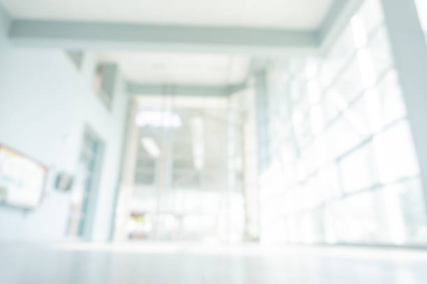 istock Abstract blurred white doctor medical office room background concept for blur empty space grey modern hospital clinic pharmacy, light clean interior retail sale, blue glare window hallway building 1182143162