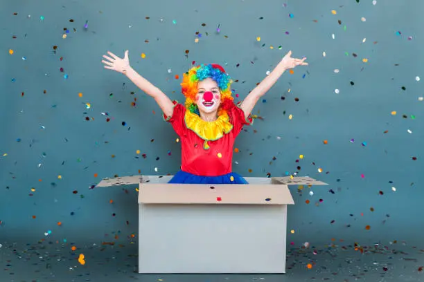 Photo of Happiness little clown jumping out of the box, toothy smiling