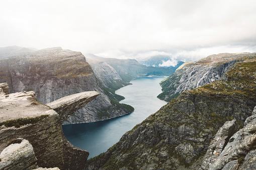 Trolltunga rock with a characteristic shape located in Norway on the border of the Hardangervidda plateau, close to the town Tyssedal. It is a popular tourist attraction in Norway and heavily visited by tourists during the summer months.