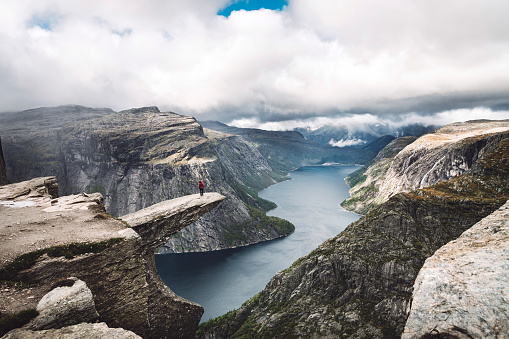 Trolltunga rock with a characteristic shape located in Norway on the border of the Hardangervidda plateau, close to the town Tyssedal. It is a popular tourist attraction in Norway and heavily visited by tourists during the summer months.