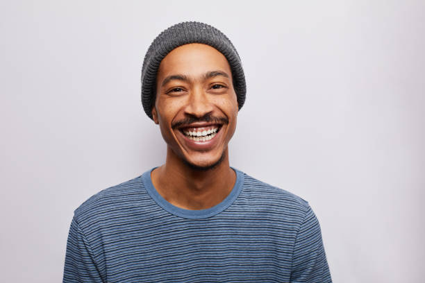 istock Fashionable young man smiling against a gray background 1182147191