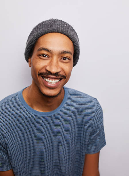 istock Casually dressed young man smiling against a gray background 1182147247