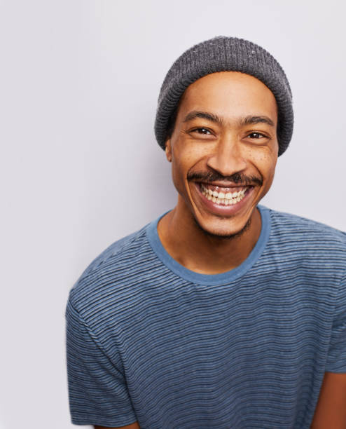 istock Stylish young man smiling against a gray background 1182147311