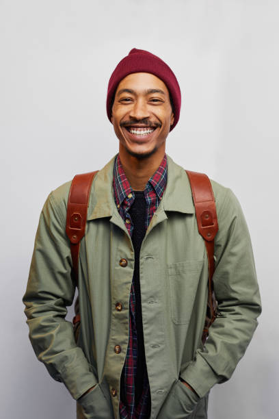 istock Young man in hiking gear standing against a gray background 1182148201