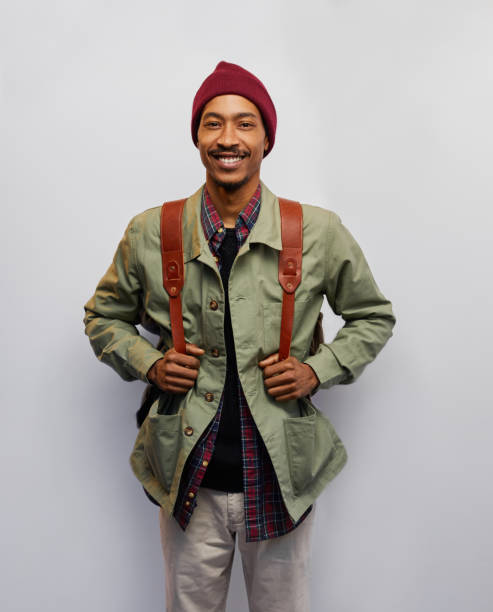istock Smiling young man ready for hiking against a gray background 1182148966