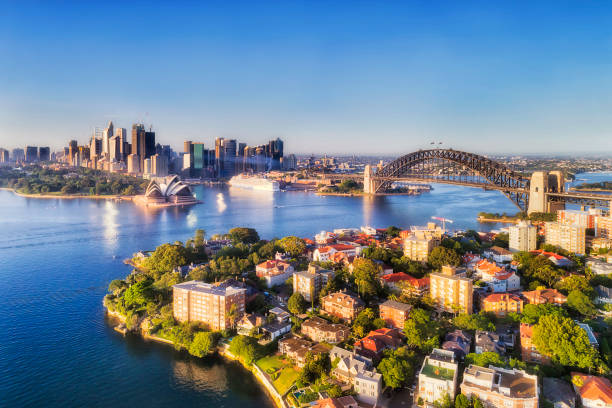 D Sy Kurraba 2 CBD over kirribilli Still blue waters of Sydney harbour between city CBD landmarking builidings connected by the Sydney Harbour bridge to North Shore wealthy suburbs with Kirribilli in forefront of aerial view. sydney harbor photos stock pictures, royalty-free photos & images