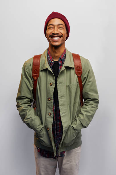istock Laughing young man wearing hiking gear on a gray background 1182149035