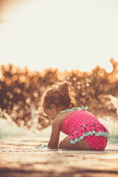 istock Water splashing while baby girl is playing 1182150046