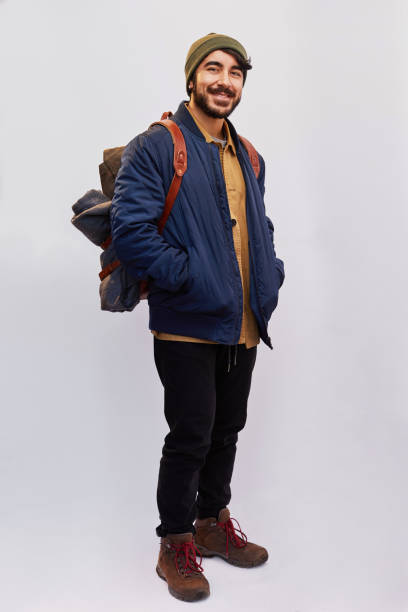 istock Smiling man ready for hiking standing against a gray background 1182152151