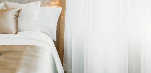 bed maid-up with clean white pillows and bed sheets in beauty bedroom. close-up. interior background - indoors window elegance tranquil scene imagens e fotografias de stock