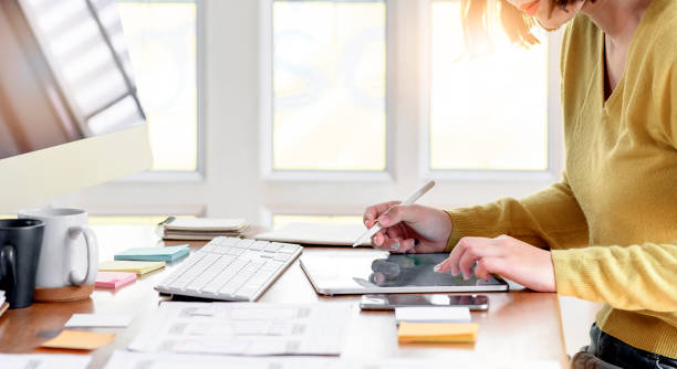 istock Young woman working with tablet for new project while sitting at modern office. 1182155440