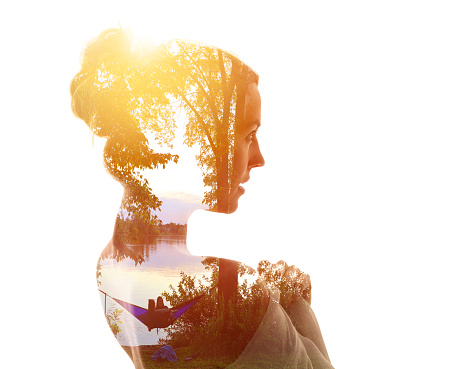 Multiple exposure of a young woman and nature