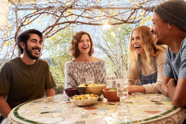 istock Laughing group of friends talking over snacks on a farm 1182159035