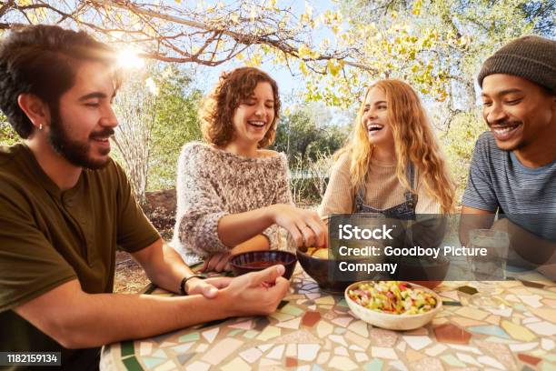 Laughing Friends Eating Nachos Togegher On An Outdoor Patio Stock Photo - Download Image Now