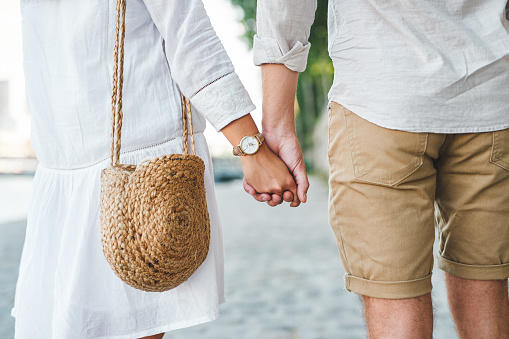 Cropped shot of a couple holding hands while out for a romantic walk in the city