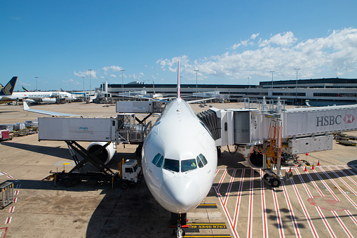 Sydney, Australia - September 28, 2019: Qantas Airbus A330 under the baggage loading and connected to aerobridge at Sydney International Airport.