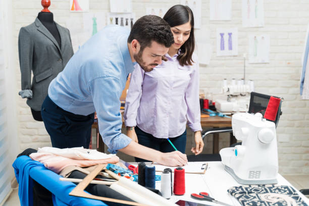 istock Fashion designer on meeting with customer in his studio 1182166251
