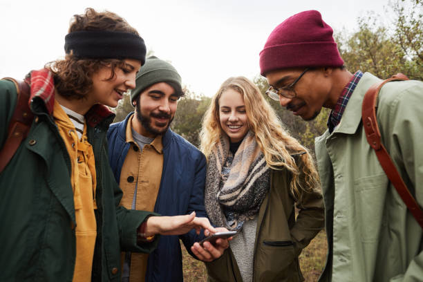istock Friends using their cellphone gps for directions while out hiking 1182170403