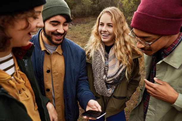 istock Smiling young friends using gps during a nature hike together 1182170997