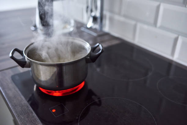 Keep a safe following distance Shot of water boiling in an open pot on a hot stove at home boiling photos stock pictures, royalty-free photos & images