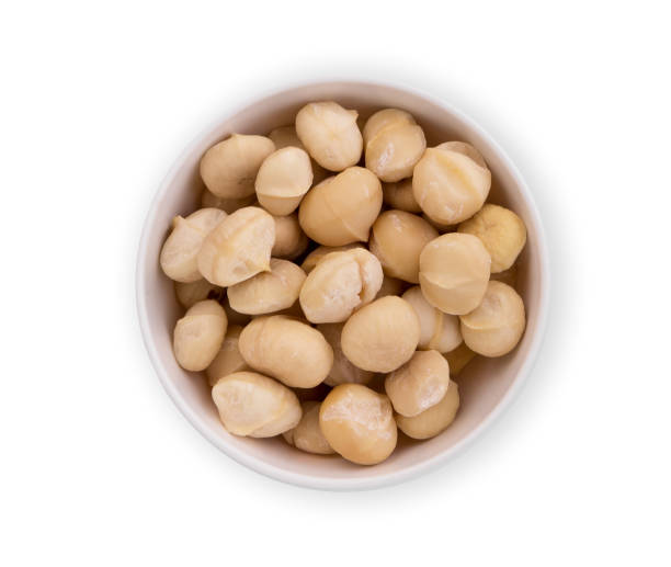 istock shelled macadamia fruit in the white bowl isolated on white background, flat lay, top view 1182171804