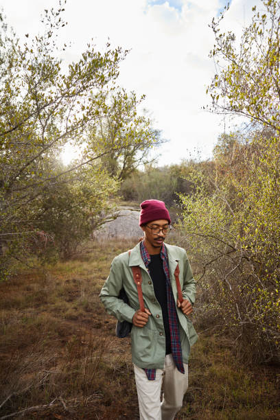 istock Young man hiking alone along a nature trail 1182172519