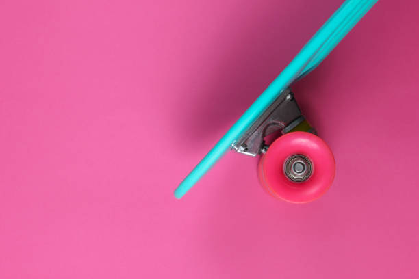 istock Plastic mini cruiser board on a pink background. Pastel color trend. Summer fun. Youth minimalistic concept. Top view 1182181897