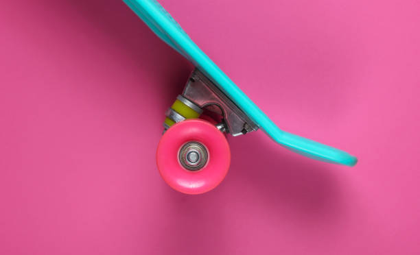istock Plastic mini cruiser board on a pink background. Pastel color trend. Summer fun. Youth minimalistic concept. Top view 1182181911