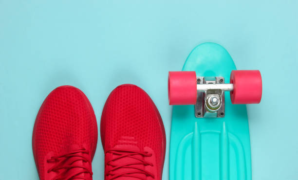 istock Cruiser board and red sneakers on blue background. Top view 1182181952