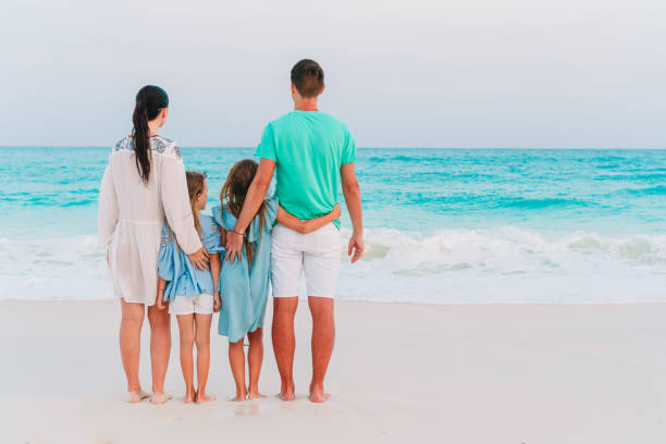 istock Happy family on the beach during summer vacation 1182184162