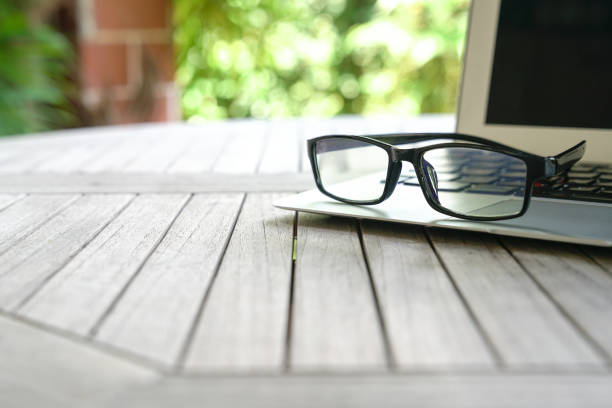 istock Reading glasses on top of keyboard with copy space 1182186266
