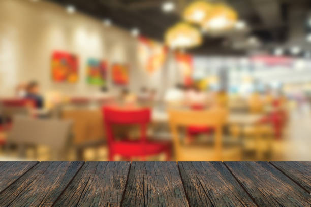 istock Defocus inside of restaurant with wood table at foreground. 1182187288