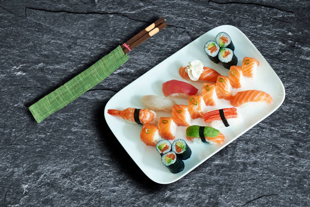 istock Plate of delicious sushis and maki over background texture 1182189521